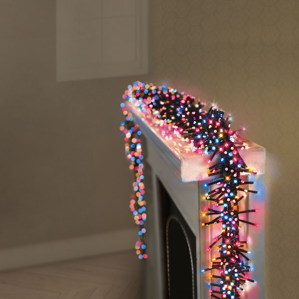 Bundle of colourful Christmas lights draped over a mantlepiece