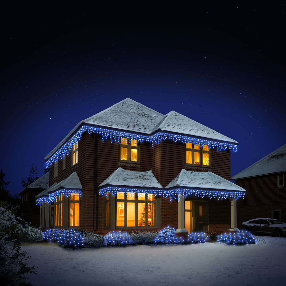 Shot of house from outside that is covered with blue and white Fern Lighting Icicle Lights