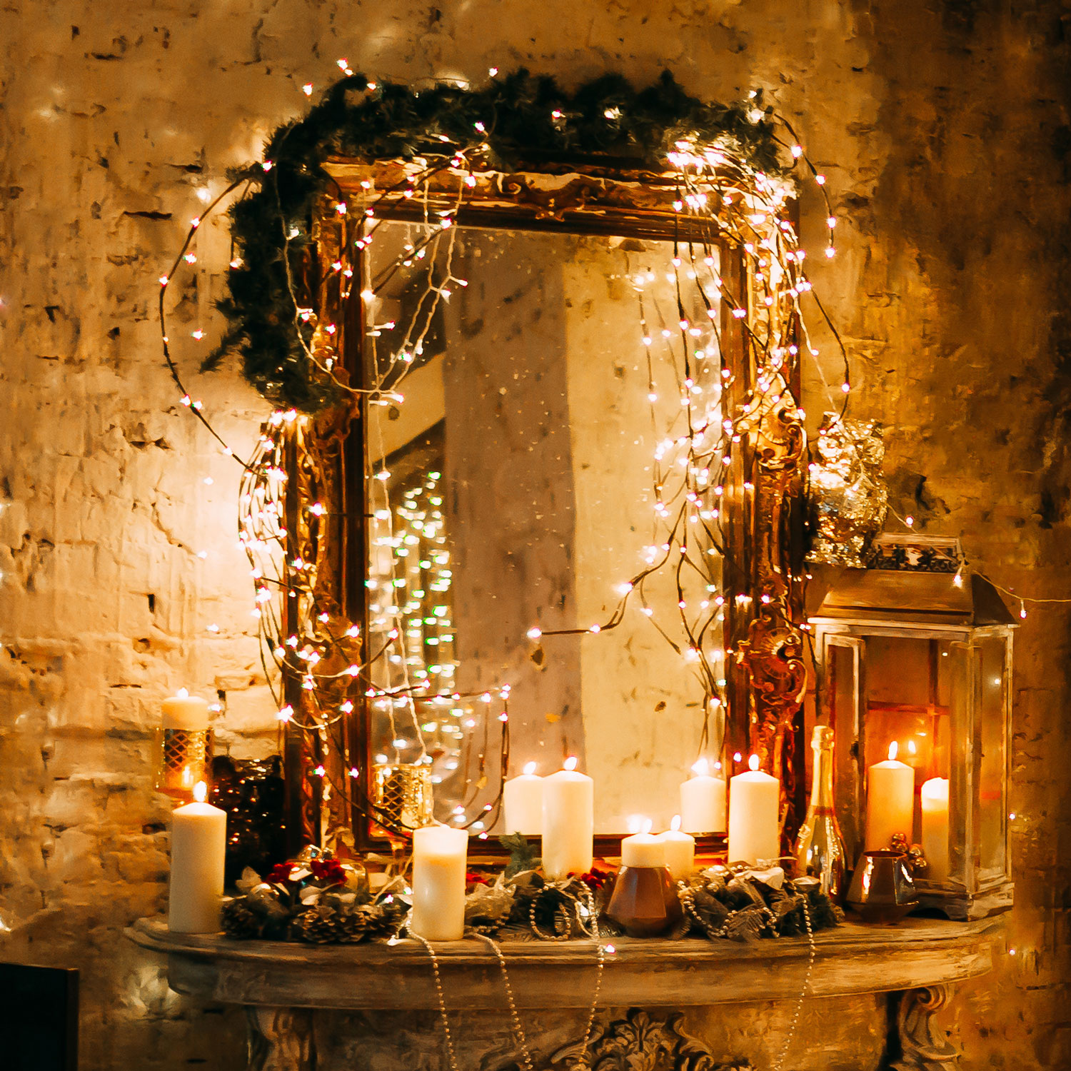 Dark room featuring a mirror on a dressing table, lit by warm white string lights